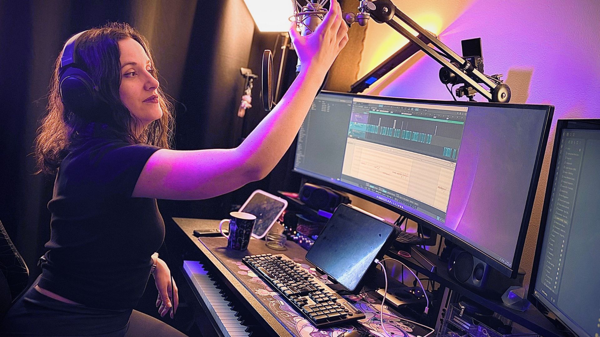 Elvann in her music studio grabbing the microphone