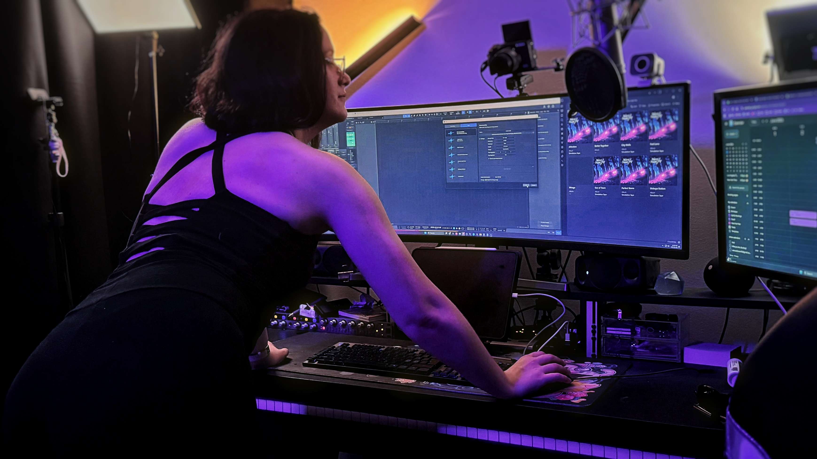 Elvann playing her pedal harp in a dark studio